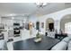 Open-concept kitchen and dining area with modern appliances, white cabinets, and seamless flow for entertaining at 402 Bramble Way, Minneola, FL 34715