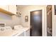 Laundry room with a washer, dryer, shelves, and storage hooks at 402 Bramble Way, Minneola, FL 34715