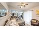 Inviting living room boasts neutral tones, ceiling fan, and an open layout connected to the kitchen at 402 Bramble Way, Minneola, FL 34715