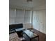 Living room with wood floors, a large window, and a comfortable seating arrangement at 5112 Conroy Rd # 17, Orlando, FL 32811