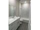 Bright bathroom features modern vanity, toilet, and tub with stylish marble tiling at 620 N 2Nd N St, Lake Hamilton, FL 33851
