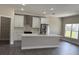 Well-lit kitchen with central island, stainless appliances, and pantry nearby at 620 N 2Nd N St, Lake Hamilton, FL 33851