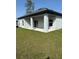 Covered outdoor patio with ample space for entertaining and sliding glass door entry to home at 620 N 2Nd N St, Lake Hamilton, FL 33851