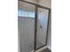 Modern shower with glass doors, neutral tile surround, and brushed nickel shower head at 620 N 2Nd N St, Lake Hamilton, FL 33851