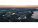 Aerial view of a golf course community surrounded by beautiful lakes and trees at 7117 Red Lantern Dr # 7117, Harmony, FL 34773