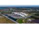 Community aerial view showcasing school, baseball diamond, and tennis courts at 7117 Red Lantern Dr # 7117, Harmony, FL 34773