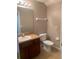 Bathroom features single sink, cabinet, mirror, and toilet at 7117 Red Lantern Dr # 7117, Harmony, FL 34773