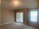Neutral bedroom with carpet, window, and glass doors leading to outdoor space at 7117 Red Lantern Dr # 7117, Harmony, FL 34773