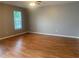 Spacious bedroom featuring hardwood floors and a bright window at 7117 Red Lantern Dr # 7117, Harmony, FL 34773