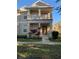 Charming two-story home with a balcony, front porch, and well-maintained landscaping at 7117 Red Lantern Dr # 7117, Harmony, FL 34773