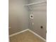 The laundry room has tile flooring and a shelf for storage at 7117 Red Lantern Dr # 7117, Harmony, FL 34773