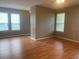 Bright living room featuring hardwood floors, neutral walls, and ample natural light at 7117 Red Lantern Dr # 7117, Harmony, FL 34773