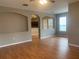Spacious living room with hardwood floors and open view to the kitchen at 7117 Red Lantern Dr # 7117, Harmony, FL 34773