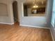 Open-concept living room with hardwood floors, neutral walls and a kitchen view at 7117 Red Lantern Dr # 7117, Harmony, FL 34773