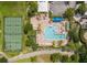 Aerial view of community pool, tennis courts, and outdoor seating for residents to enjoy at 7117 Red Lantern Dr # 7117, Harmony, FL 34773