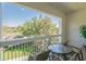 Enjoy the view from this private balcony with a table and chairs perfect for relaxing outdoors at 7697 Heritage Crossing Way # 302, Reunion, FL 34747