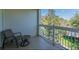 Relax on this covered balcony with chairs and enjoy the peaceful outdoor views at 7697 Heritage Crossing Way # 302, Reunion, FL 34747