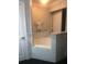 Bathroom with white bathtub and tiled surround at 7697 Heritage Crossing Way # 302, Reunion, FL 34747
