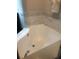 Bright white bathtub with marble-style tile accents at 7697 Heritage Crossing Way # 302, Reunion, FL 34747