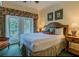 Comfortable bedroom with French doors, a king bed, and neutral tones, perfect for relaxation at 7697 Heritage Crossing Way # 302, Reunion, FL 34747