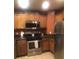 Modern kitchen features stainless steel appliances, tile floors, and a breakfast bar at 7697 Heritage Crossing Way # 302, Reunion, FL 34747