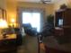 Cozy living room with plush seating, a ceiling fan, and lots of natural light at 7697 Heritage Crossing Way # 302, Reunion, FL 34747