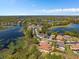 The aerial view shows the houses in this lake community at 800 Stephens Pass Cv, Lake Mary, FL 32746