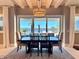 Dining room with black wood table set on an area rug and water views at 800 Stephens Pass Cv, Lake Mary, FL 32746
