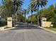 This is the entrance to a private community surrounded by palm trees at 800 Stephens Pass Cv, Lake Mary, FL 32746