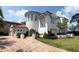 Elegant two-story home featuring a stucco exterior, tiled roof, arched entryway, and lush landscaping at 800 Stephens Pass Cv, Lake Mary, FL 32746