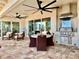 Outdoor kitchen and dining area with stainless steel grill and ceiling fans at 800 Stephens Pass Cv, Lake Mary, FL 32746