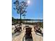 Outdoor patio with chairs surrounding a cozy fire pit and scenic water views at 800 Stephens Pass Cv, Lake Mary, FL 32746