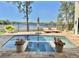 Backyard with a tranquil pool, spa, and views of the lake at 800 Stephens Pass Cv, Lake Mary, FL 32746