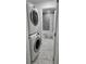 Bathroom with modern stacked laundry and updated shower at 906 Se 3Rd St, Mulberry, FL 33860