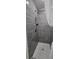 Modern bathroom shower with gray tiling and mosaic flooring at 906 Se 3Rd St, Mulberry, FL 33860