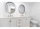 Bathroom with dual sinks, modern fixtures, and white cabinets offer both style and functionality at 906 Se 3Rd St, Mulberry, FL 33860