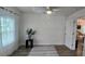 Bright bedroom with ample natural light, neutral paint, and wood look flooring at 906 Se 3Rd St, Mulberry, FL 33860