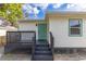 Home with a wooden deck showcasing black painted railings and stairs to the yard at 906 Se 3Rd St, Mulberry, FL 33860