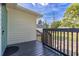 Exterior side shot showing the deck with black railings and a view of the grassy yard at 906 Se 3Rd St, Mulberry, FL 33860