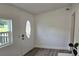 Bright entryway featuring modern flooring, a window, and a decorative door with glass at 906 Se 3Rd St, Mulberry, FL 33860