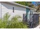 Exterior of a home showcasing modern siding, a well-maintained lawn, and beautiful landscaping at 906 Se 3Rd St, Mulberry, FL 33860