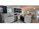 Stylish kitchen with stainless appliances, island cooktop, and open layout to the living area at 906 Se 3Rd St, Mulberry, FL 33860