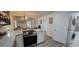 Charming kitchen featuring granite countertops, stainless steel appliances, and views into the living room at 906 Se 3Rd St, Mulberry, FL 33860