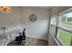 Bright office space featuring wood-look floors, natural light, and a white desk at 906 Se 3Rd St, Mulberry, FL 33860