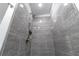Modern gray tiled walk-in shower featuring a sleek shower head and built-in niche at 906 Se 3Rd St, Mulberry, FL 33860