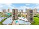 Stunning aerial view of beachfront condos, pool, and manicured grounds, showcasing coastal living at its finest at 1 Oceans West Blvd # 3B4, Daytona Beach, FL 32118