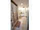 Cozy bathroom with tiled floor, wood vanity and shell-themed shower curtain at 1 Oceans West Blvd # 3B4, Daytona Beach, FL 32118
