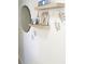 Modern wall decor featuring floating shelves, round mirror, and leaf accents at 1 Oceans West Blvd # 3B4, Daytona Beach, FL 32118