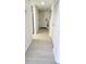 Clean hallway featuring updated flooring, white walls, and ample closet space at 1 Oceans West Blvd # 3B4, Daytona Beach, FL 32118