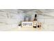 Close-up of a decorated kitchen counter with coffee-themed decor and stylish tile backsplash at 1 Oceans West Blvd # 3B4, Daytona Beach, FL 32118